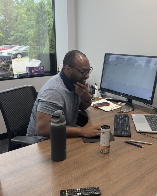 Asaph at his desk at the Encore office